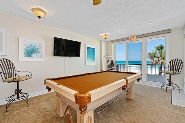 recreation room featuring carpet flooring, pool table, a textured ceiling, and baseboards