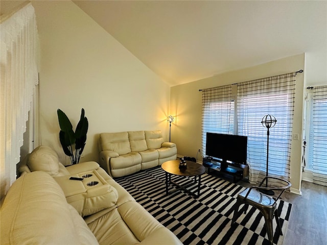 living room with high vaulted ceiling and hardwood / wood-style flooring