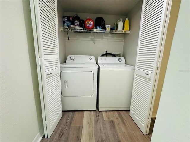 laundry room featuring light hardwood / wood-style flooring and separate washer and dryer