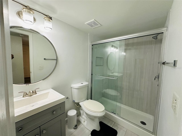 bathroom with walk in shower, vanity, tile patterned flooring, and toilet