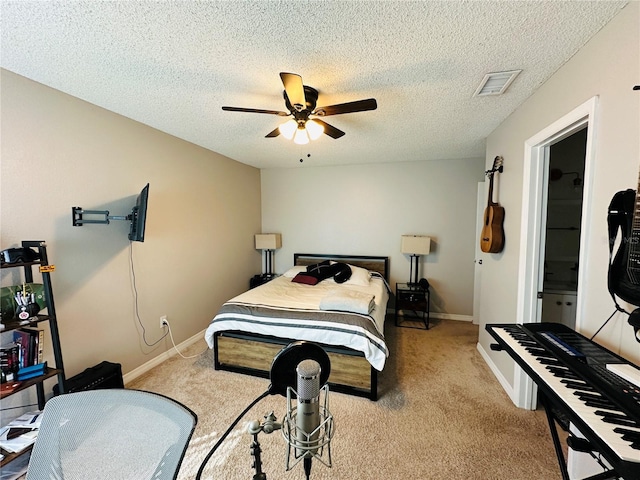 bedroom with ceiling fan, a textured ceiling, and light colored carpet