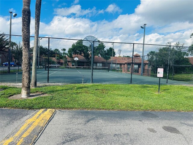 view of tennis court with basketball hoop