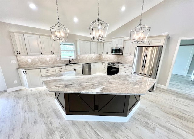 kitchen featuring appliances with stainless steel finishes, light hardwood / wood-style flooring, tasteful backsplash, and white cabinetry