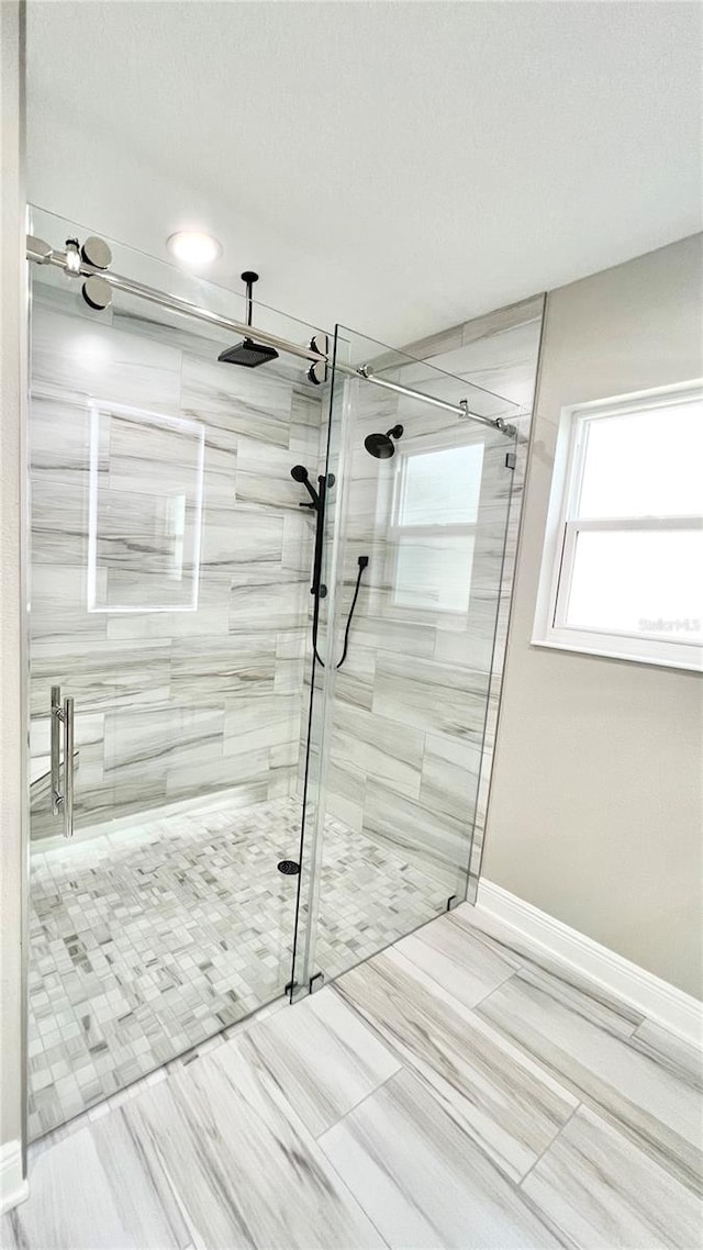 bathroom featuring tile patterned flooring and a shower with shower door