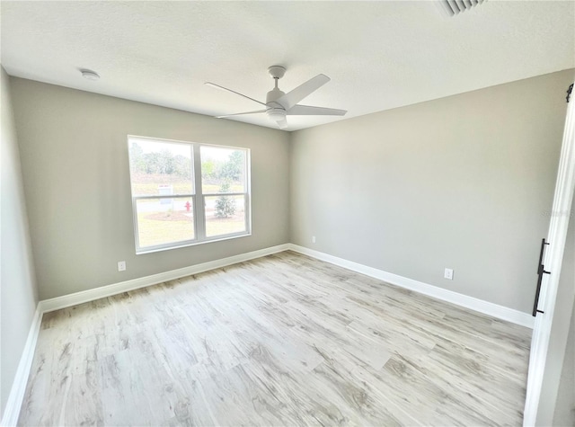 spare room featuring ceiling fan and light wood-type flooring