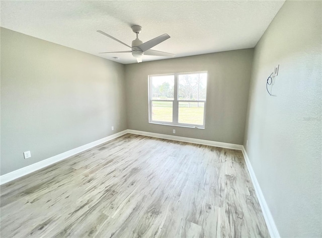 spare room featuring ceiling fan, a textured ceiling, and light hardwood / wood-style floors