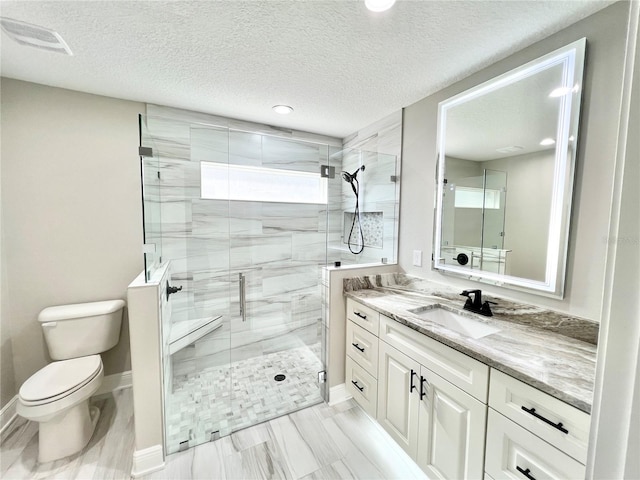 bathroom with a textured ceiling, toilet, a shower with shower door, tile patterned floors, and vanity