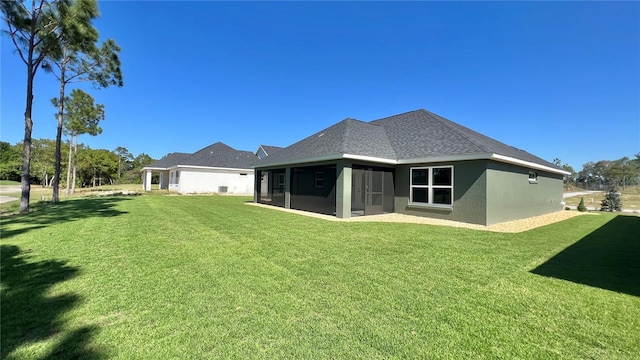 back of property featuring a lawn and a sunroom