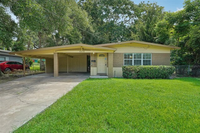 view of front of property with a carport and a front yard