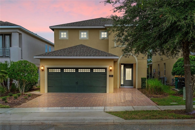 view of front facade featuring cooling unit and a garage