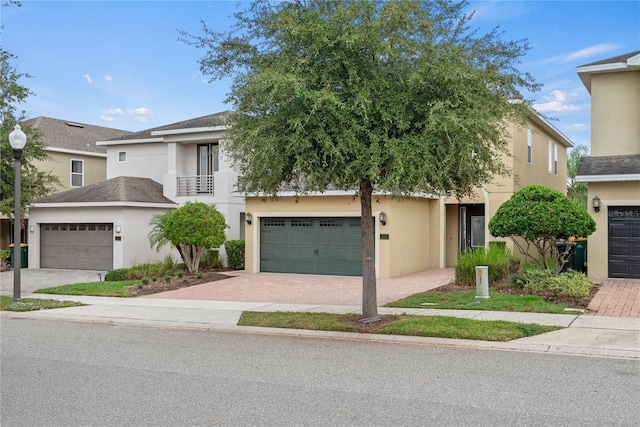 view of front of home with a garage and a balcony