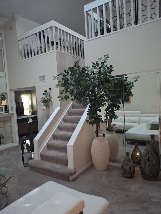 2909 Clubview Unit 2909, Orlando, FL 32822 - staircase with a high ceiling and carpet floors