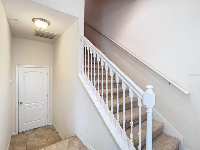 stairs with light tile patterned floors