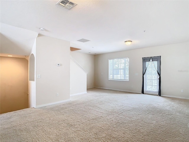 spare room with light colored carpet