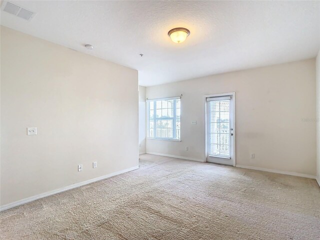 unfurnished room with light colored carpet