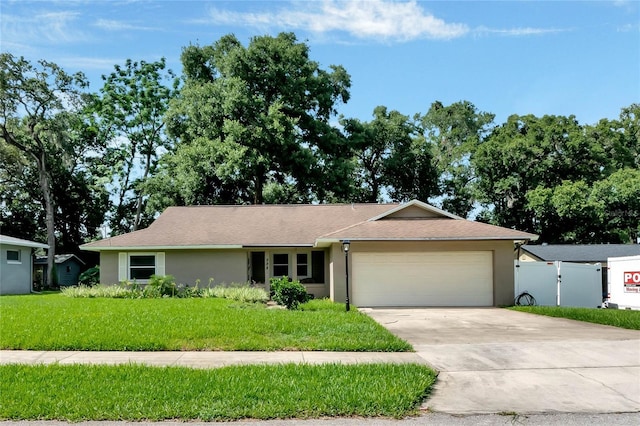 ranch-style home featuring a front lawn and a garage