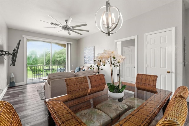 interior space with ceiling fan with notable chandelier and wood-type flooring