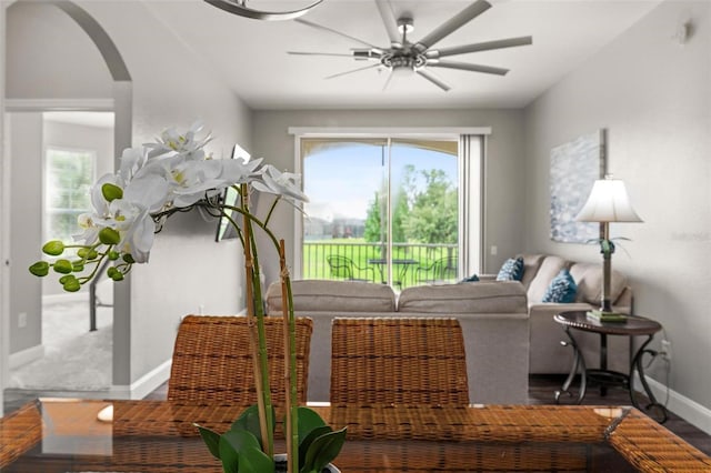 8105 Coconut Palm Way Unit 203, Kissimmee, FL 34747 - living room with arched walkways, wood finished floors, and ceiling fan