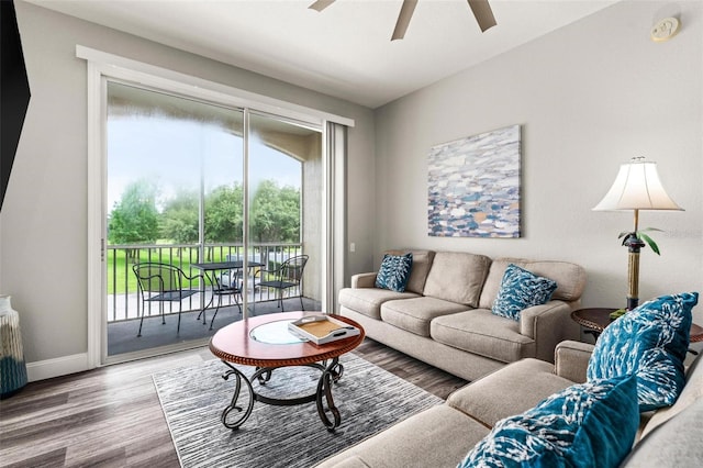 living room featuring hardwood / wood-style floors and ceiling fan