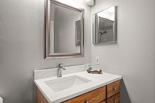 8105 Coconut Palm Way Unit 203, Kissimmee, FL 34747 - bathroom with vanity and a textured wall