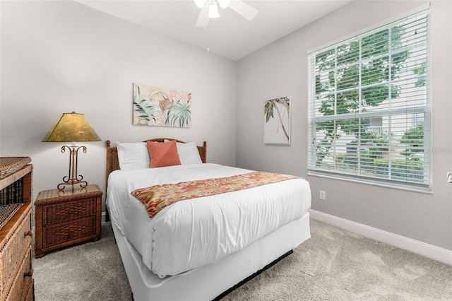 carpeted bedroom with ceiling fan and multiple windows