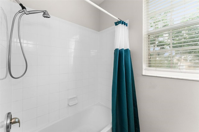 bathroom with shower / tub combo with curtain