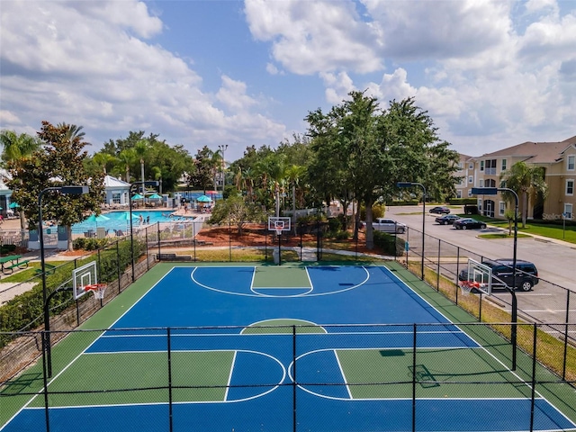 view of sport court with a community pool