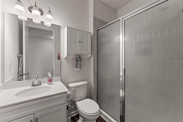 bathroom featuring an enclosed shower, toilet, and vanity