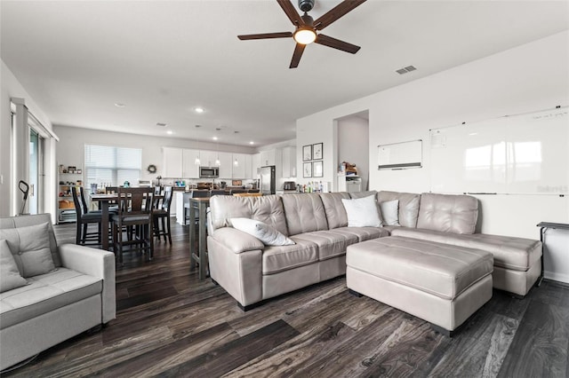 living room with ceiling fan and hardwood / wood-style flooring