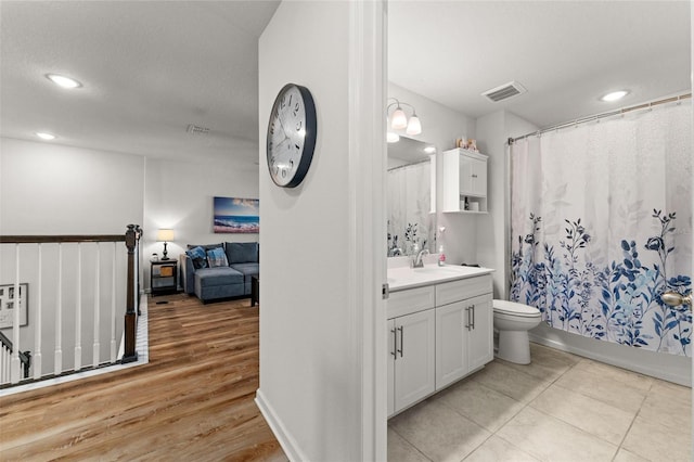 bathroom with vanity, hardwood / wood-style floors, and toilet