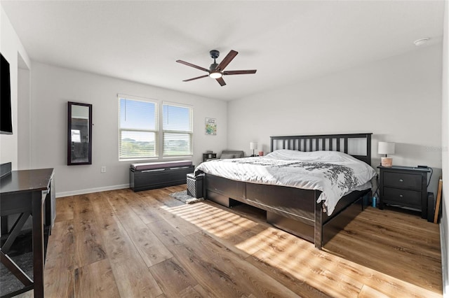 bedroom with ceiling fan and hardwood / wood-style floors