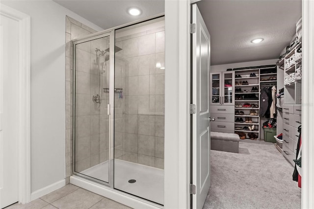 bathroom featuring tile patterned flooring and an enclosed shower