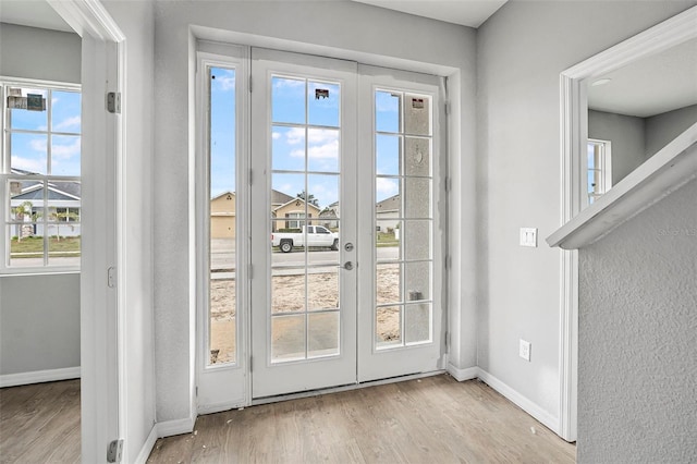 doorway featuring french doors and light hardwood / wood-style flooring