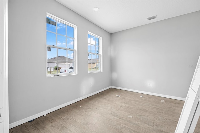 unfurnished room with hardwood / wood-style floors