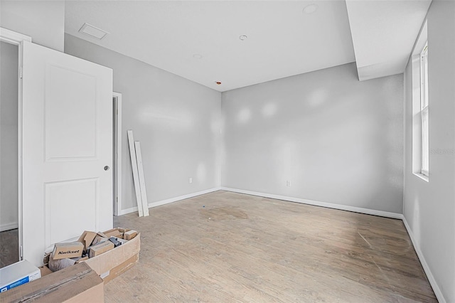 empty room with hardwood / wood-style flooring