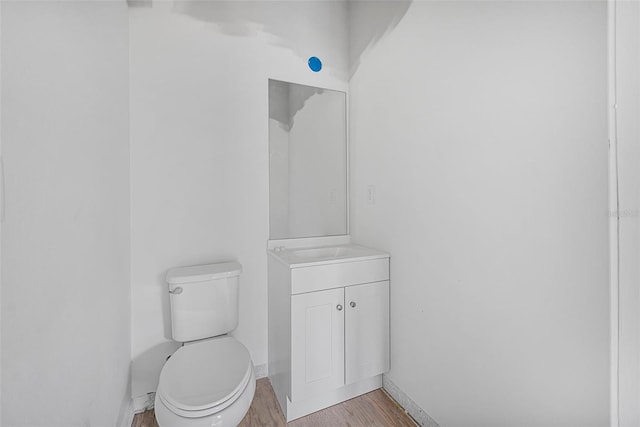 bathroom featuring vanity, hardwood / wood-style floors, and toilet