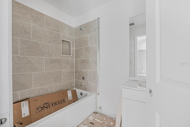 bathroom with tiled shower / bath and vanity