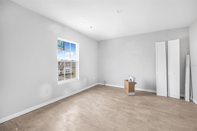 unfurnished room featuring light wood-type flooring