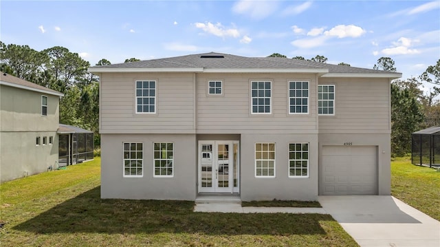 view of front of property featuring concrete driveway, an attached garage, french doors, a front lawn, and stucco siding