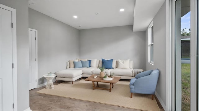 living room featuring plenty of natural light, baseboards, wood finished floors, and recessed lighting