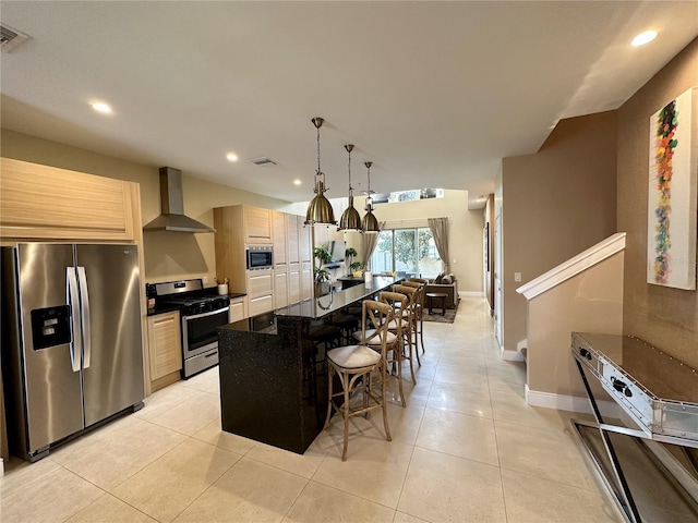 kitchen featuring visible vents, light brown cabinetry, stainless steel appliances, wall chimney exhaust hood, and light tile patterned floors