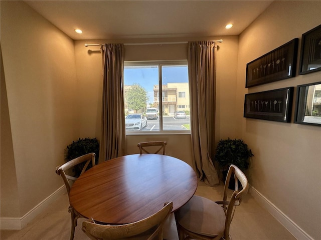 dining space with light carpet, recessed lighting, and baseboards