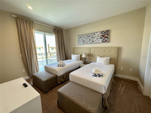 carpeted bedroom featuring baseboards and access to outside