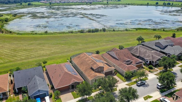 drone / aerial view featuring a residential view and a water view