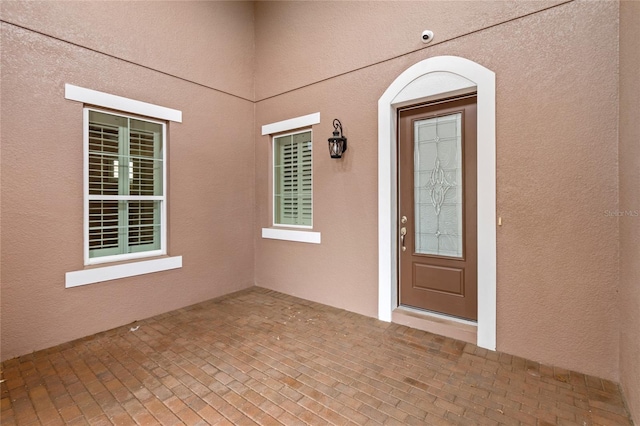 entrance to property with stucco siding