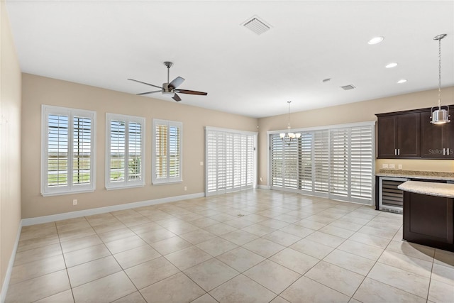 unfurnished living room featuring visible vents, baseboards, beverage cooler, light tile patterned floors, and recessed lighting