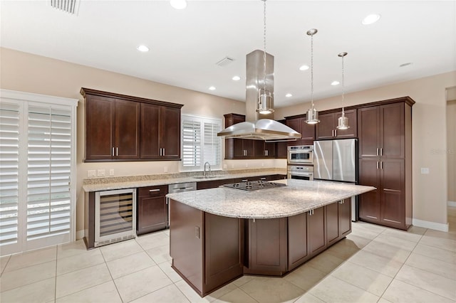 kitchen featuring visible vents, island exhaust hood, stainless steel appliances, a sink, and wine cooler