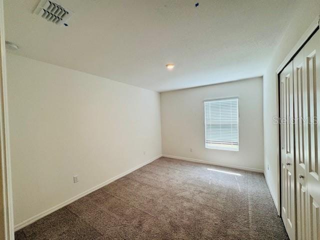 unfurnished bedroom featuring a closet and carpet flooring