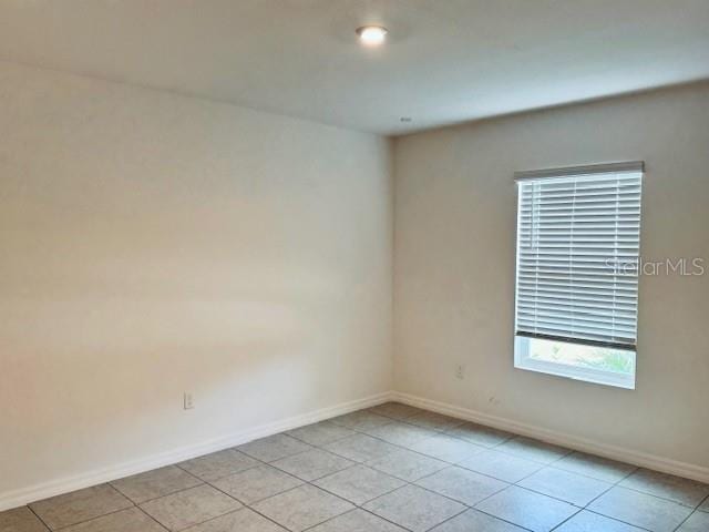 unfurnished room with light tile patterned floors