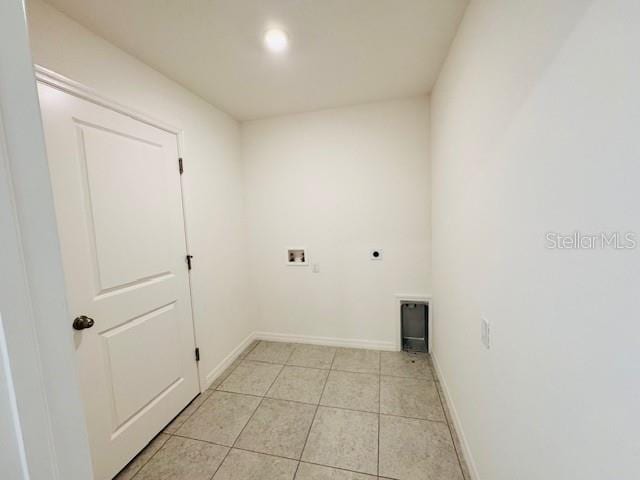 clothes washing area featuring hookup for a washing machine, light tile patterned flooring, and hookup for an electric dryer